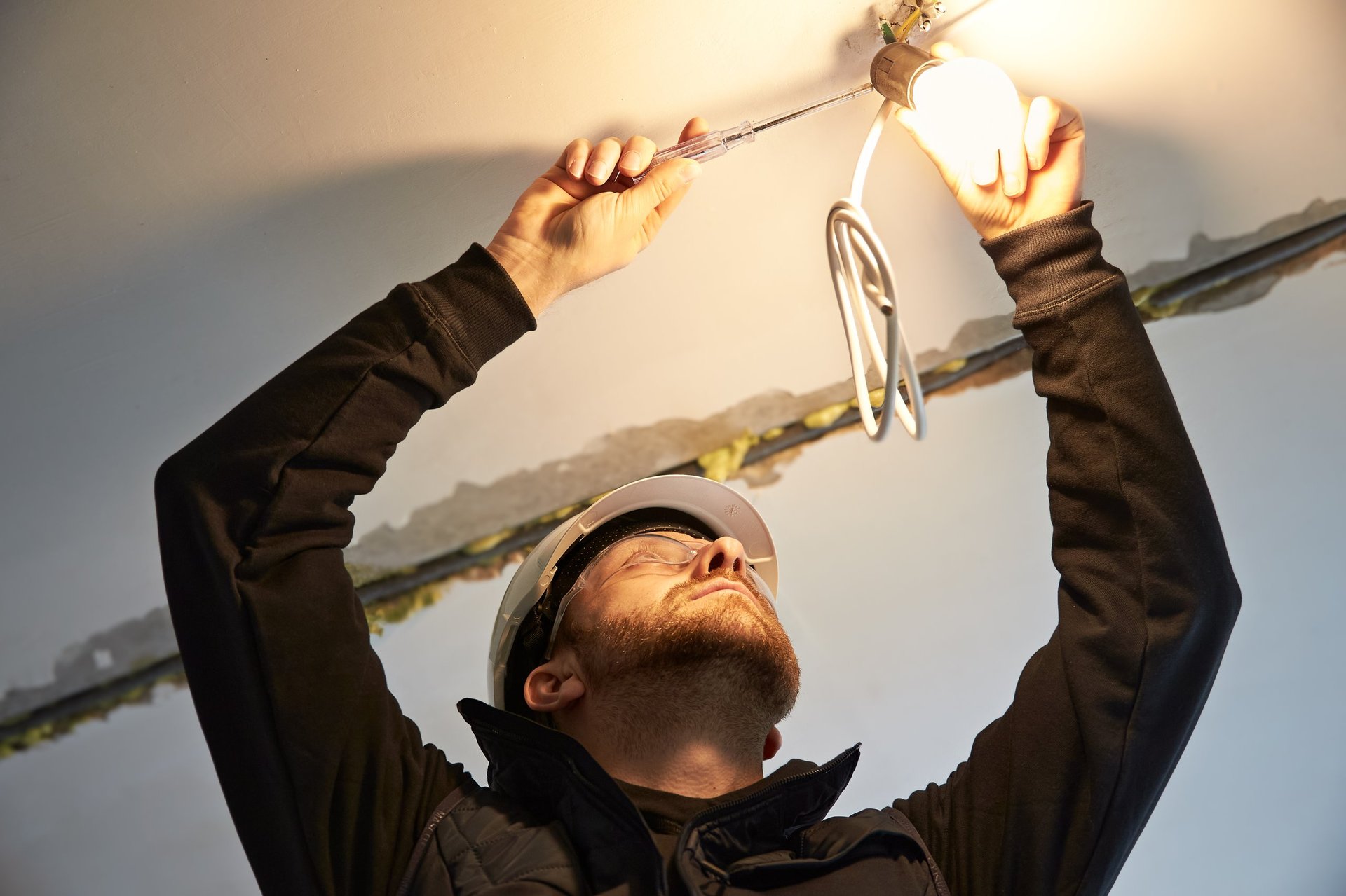 Portrait of male electrician working on wiring